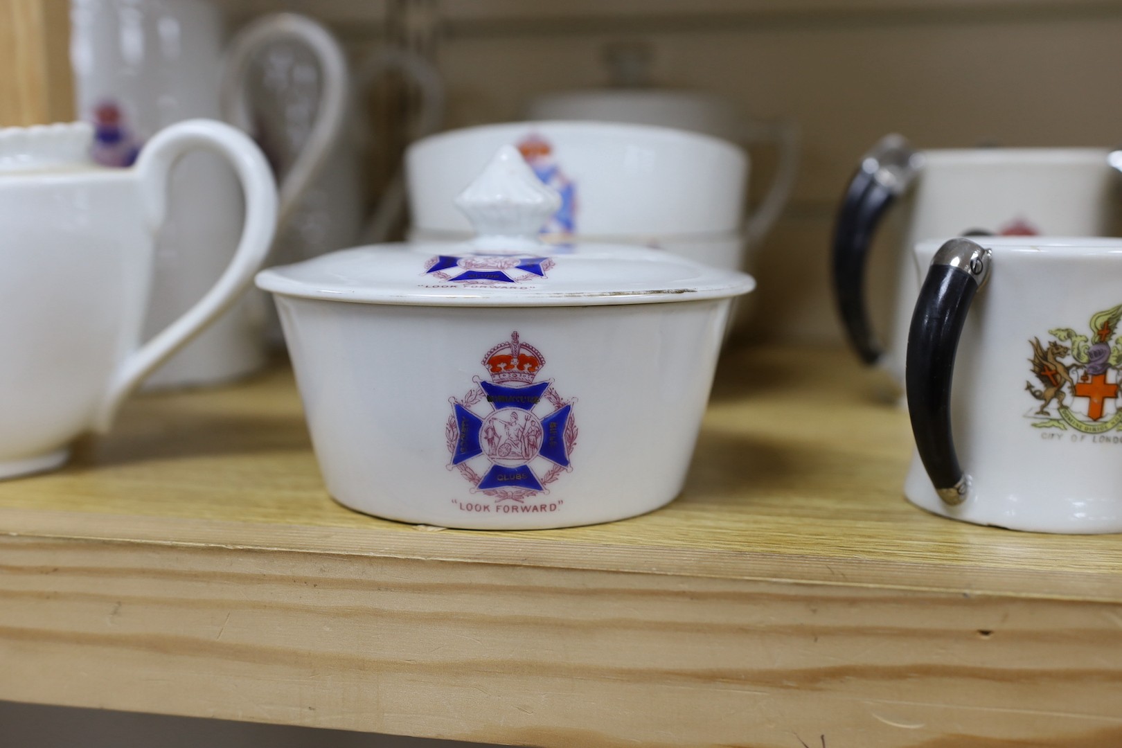 Society of Miniature Rifle Clubs - A large group of commemorative porcelain tea wares, three handled tygs and plates awarded for skill in rifle shooting, early 20th century